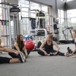 IFTA instructors stretching on the gym floor